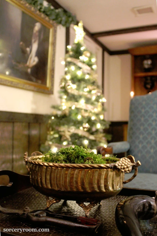 Harry Potter Christmas tree - fully decorated Hogwarts style tree with lit a bronze bowl in the foreground