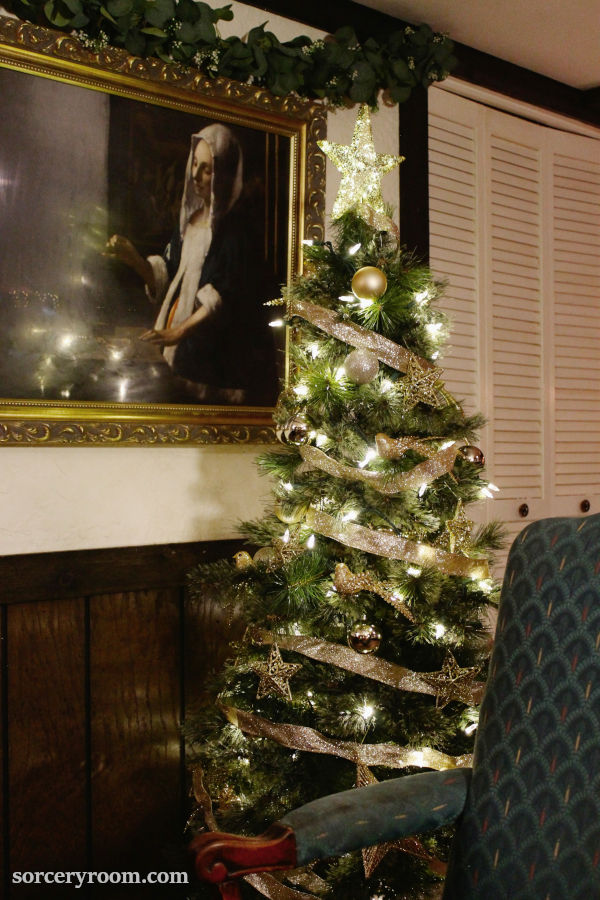 Harry Potter Christmas tree - fully decorated Hogwarts style tree with a chair in the foreground