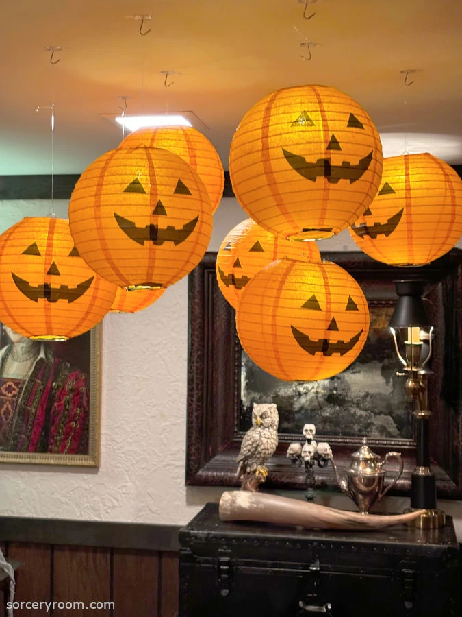 Harry Potter themed Halloween décor - floating paper lantern pumpkins in a Hogwarts themed room